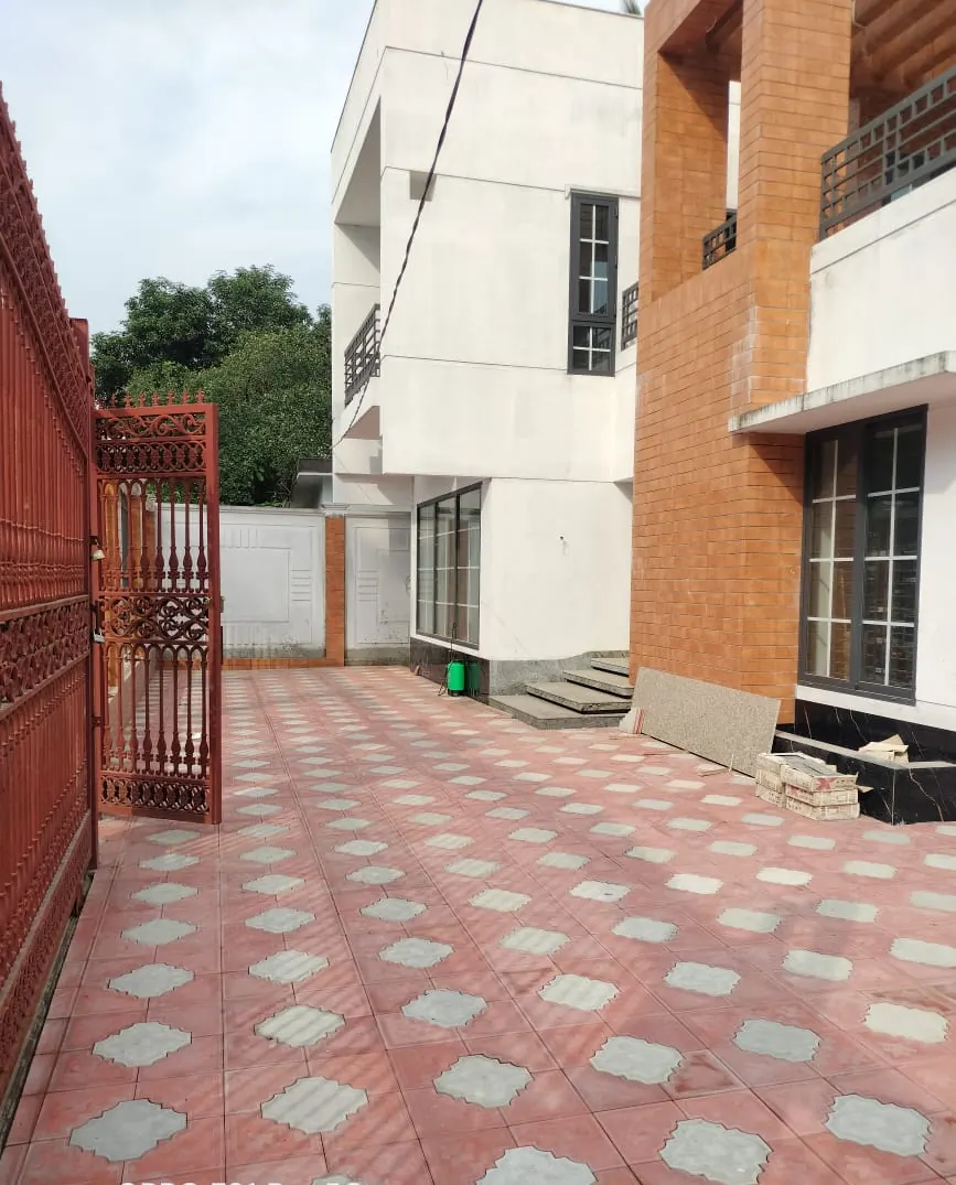 Residential driveway laid with red and white parking tiles, Dhaka