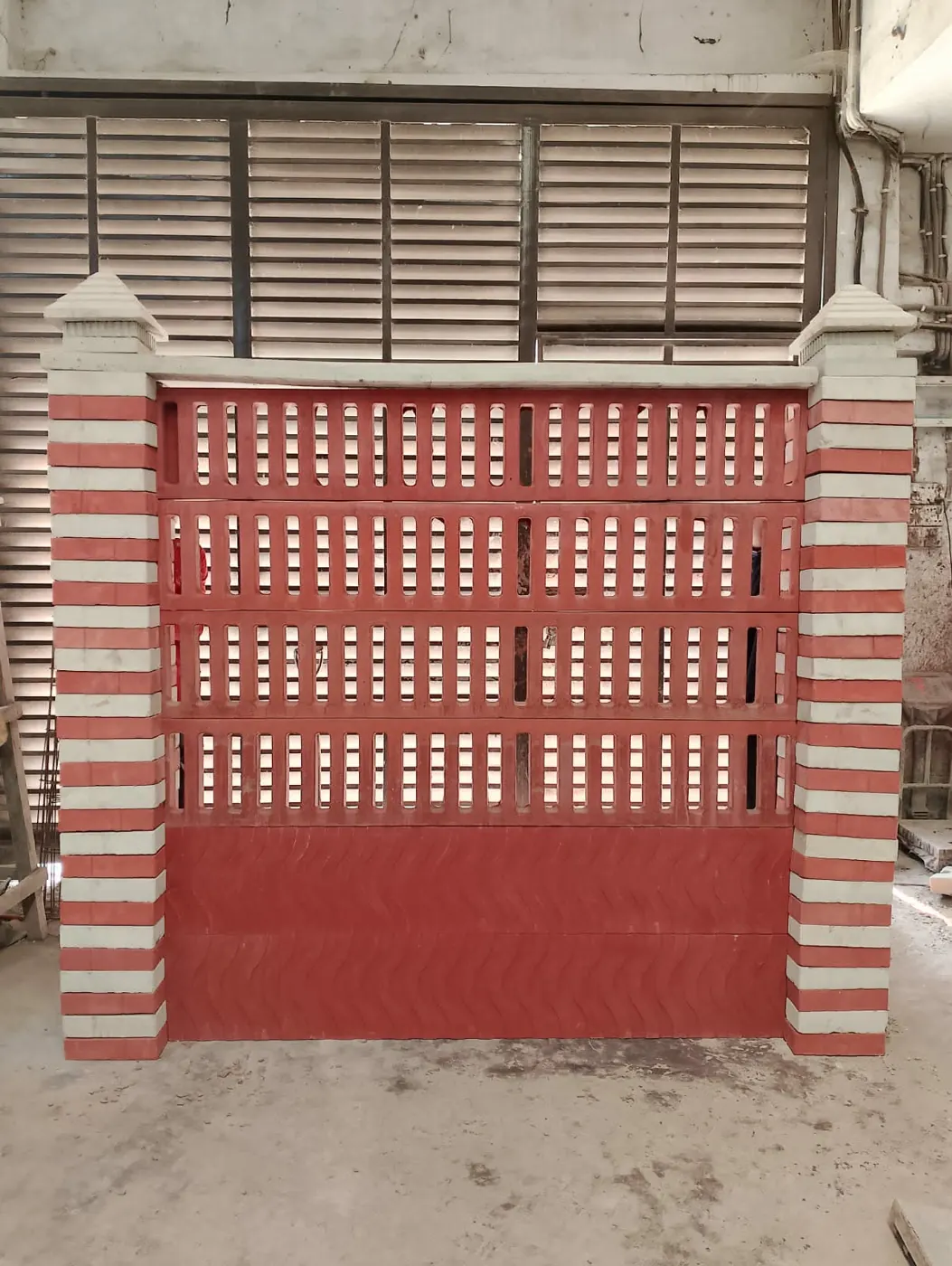 Ventilation wall panel beside a gate opening