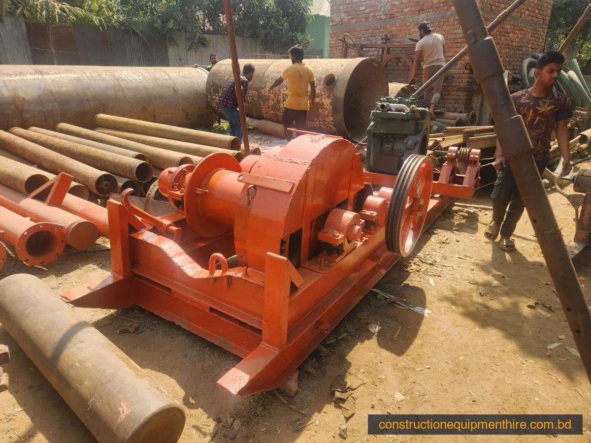 Winch machine for a percussion piling rig