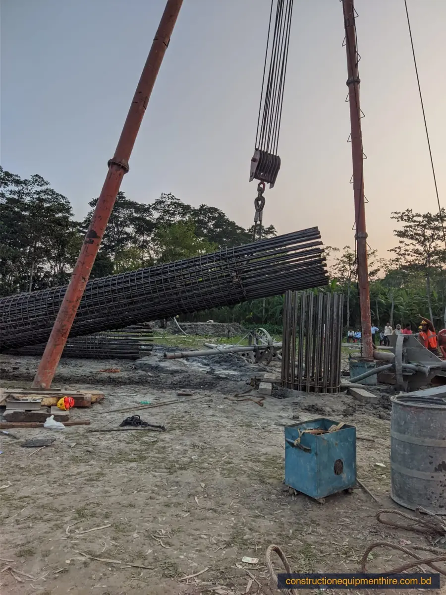 Crane lifting a rebar cage on site